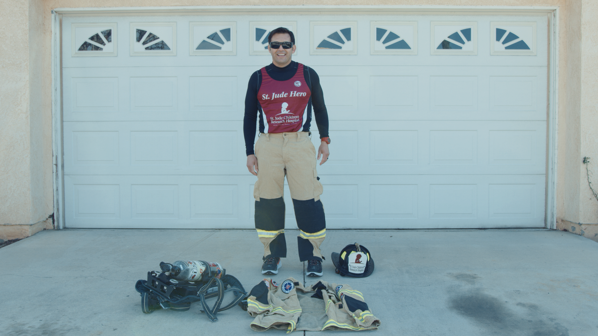 Jose Zambrano demonstrating his firefighter gear.